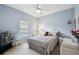 Comfortable bedroom with blue walls, a ceiling fan, and a quaint white bedside table at 324 Sorrento Rd, Poinciana, FL 34759