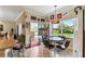 Charming breakfast nook with views of outdoor landscaping, adjacent to the kitchen at 324 Sorrento Rd, Poinciana, FL 34759