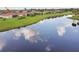 This home features a backyard overlooking a tranquil lake, enhancing its appeal and scenic backdrop at 324 Sorrento Rd, Poinciana, FL 34759