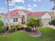 Inviting home exterior with stone accents, tropical landscaping, and a well-manicured lawn at 324 Sorrento Rd, Poinciana, FL 34759