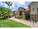 Charming home with stone accents, lush landscaping, and a welcoming walkway at 324 Sorrento Rd, Poinciana, FL 34759