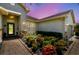 Beautiful home exterior with stone facade, brick walkway, and lush tropical landscaping at 324 Sorrento Rd, Poinciana, FL 34759