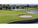Lush green golf course landscape with scenic water views and surrounding mature trees at 324 Sorrento Rd, Poinciana, FL 34759