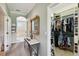 Hallway showcasing a decorative table and mirror leading to a walk-in closet at 324 Sorrento Rd, Poinciana, FL 34759