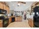 Open kitchen layout with black appliances and abundant storage and countertop space at 324 Sorrento Rd, Poinciana, FL 34759