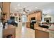 Well-lit kitchen offers black appliances, wooden cabinetry, and tile flooring at 324 Sorrento Rd, Poinciana, FL 34759