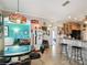 Eclectic eat-in kitchen featuring retro Coca-Cola decor, unique lighting, and bar seating at 324 Sorrento Rd, Poinciana, FL 34759