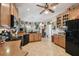 Spacious kitchen with ample cabinet space, black appliances, and tile floors at 324 Sorrento Rd, Poinciana, FL 34759