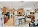 Open concept kitchen and living area with breakfast bar and tile floors at 324 Sorrento Rd, Poinciana, FL 34759