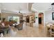 Open living room features tile floors, a ceiling fan, and a seamless connection to the dining area at 324 Sorrento Rd, Poinciana, FL 34759
