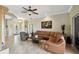 Elegant living room with tile flooring, a ceiling fan, and an open design perfect for modern living at 324 Sorrento Rd, Poinciana, FL 34759