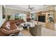Spacious living room featuring tile floors, a ceiling fan, and an open layout ideal for entertaining at 324 Sorrento Rd, Poinciana, FL 34759