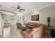 Bright living room showcasing tile flooring, contemporary furnishings, and an open layout to the dining area at 324 Sorrento Rd, Poinciana, FL 34759