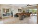 Cozy living room with tile flooring, neutral walls, and a sliding glass door to the outdoor patio at 324 Sorrento Rd, Poinciana, FL 34759