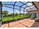 A spacious, screened-in patio offers a relaxing outdoor space with a geometric tiled floor at 324 Sorrento Rd, Poinciana, FL 34759