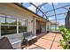 Enclosed patio boasts geometric tile floors and tranquil views of the backyard and pond at 324 Sorrento Rd, Poinciana, FL 34759
