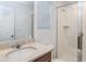 Bright bathroom featuring granite counters, framed mirror, and walk-in shower at 8937 Amelia Downs Trl, Kissimmee, FL 34747