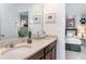 Bathroom with double sinks and large mirror at 8937 Amelia Downs Trl, Kissimmee, FL 34747
