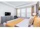 Bright bedroom with a comfortable bed, modern furniture, and a large window allowing for natural light at 8937 Amelia Downs Trl, Kissimmee, FL 34747