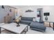 Spacious living room featuring a gray sectional sofa, modern decor, and stylish coffee table for relaxing at 8937 Amelia Downs Trl, Kissimmee, FL 34747