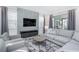 Comfortable living room with modern furniture, large TV, and stylish decor perfect for relaxation and entertainment at 8937 Amelia Downs Trl, Kissimmee, FL 34747