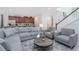 Open-concept living room adjoining a kitchen, featuring a comfortable seating area and modern decor at 8937 Amelia Downs Trl, Kissimmee, FL 34747