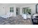 Covered patio with lounge chairs, outdoor dining, and grill area at 8937 Amelia Downs Trl, Kissimmee, FL 34747