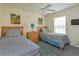 Guest bedroom with twin beds and a ceiling fan at 2005 Royal Ridge Dr, Davenport, FL 33896