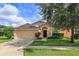 Single-Gathering home with a two-car garage and lawn at 2005 Royal Ridge Dr, Davenport, FL 33896