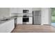 Modern kitchen featuring stainless steel appliances, granite countertops and wood flooring at 14927 Sw 25Th Cir, Ocala, FL 34473