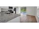 Modern kitchen featuring stainless steel appliances, granite countertops, and access to the backyard at 14927 Sw 25Th Cir, Ocala, FL 34473