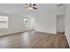 Bright living room featuring wood floors, ceiling fan, and natural light from two windows at 14927 Sw 25Th Cir, Ocala, FL 34473
