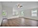 Open concept living room with wood flooring, a ceiling fan, and view into the modern kitchen at 14927 Sw 25Th Cir, Ocala, FL 34473