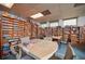 Community library featuring floor-to-ceiling bookshelves, tables with chairs, and ample natural light from the windows at 4331 Valencia Dr, Indian Lake Estates, FL 33855