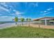 Picturesque picnic area on the beach, featuring a covered shelter and picnic tables with lake views at 4331 Valencia Dr, Indian Lake Estates, FL 33855