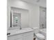 Bathroom featuring a single sink vanity with a mirror, toilet, and a bathtub with tiled walls at 4711 Sw 136Th Pl, Ocala, FL 34473