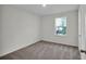 Bright bedroom with a plush carpet, a window, and white walls, creating a serene and inviting space at 4711 Sw 136Th Pl, Ocala, FL 34473