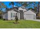 Charming home with a manicured lawn and neutral siding offers great curb appeal at 4711 Sw 136Th Pl, Ocala, FL 34473