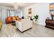 Bright living room featuring tile flooring, neutral walls, and comfortable seating at 590 Tanaro Ln, Haines City, FL 33844