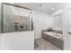 Clean and modern bathroom featuring a glass shower, soaking tub, and neutral tile at 2901 Protagonist St, Kissimmee, FL 34746
