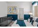 Cozy bedroom showcasing a crib and a neatly made bed at 2901 Protagonist St, Kissimmee, FL 34746