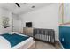 Well-lit bedroom featuring modern furniture and a gray baby crib at 2901 Protagonist St, Kissimmee, FL 34746