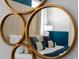 The mirrored view reveals a bedroom with a white bed and accent pillows with lots of natural light at 2901 Protagonist St, Kissimmee, FL 34746