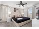 This bedroom features a queen-size bed, ceiling fan, carpeted floors, and white nightstands and lamps at 2901 Protagonist St, Kissimmee, FL 34746