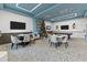 Community clubhouse featuring a game room with a Christmas tree, tables, chairs, and multiple TVs at 2901 Protagonist St, Kissimmee, FL 34746