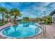 Large community pool area with palm trees, lounge chairs, and tiki hut, creating a vacation-like experience at 2901 Protagonist St, Kissimmee, FL 34746