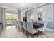 Dining room with a modern chandelier and large sliding glass doors leading to a screened patio at 2901 Protagonist St, Kissimmee, FL 34746