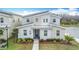 Eye-catching modern home boasting a stylish facade, unique roofline, and manicured front yard at 2901 Protagonist St, Kissimmee, FL 34746