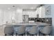 This kitchen features a stainless steel fridge, white cabinets, bar seating, and modern countertops at 2901 Protagonist St, Kissimmee, FL 34746