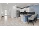 Bright kitchen with stainless steel appliances, white cabinetry, breakfast bar, and modern pendant lighting at 2901 Protagonist St, Kissimmee, FL 34746